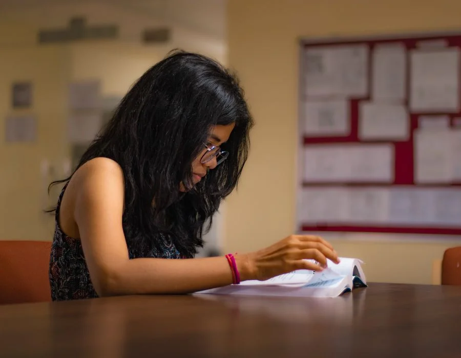 A student reading in a warm room