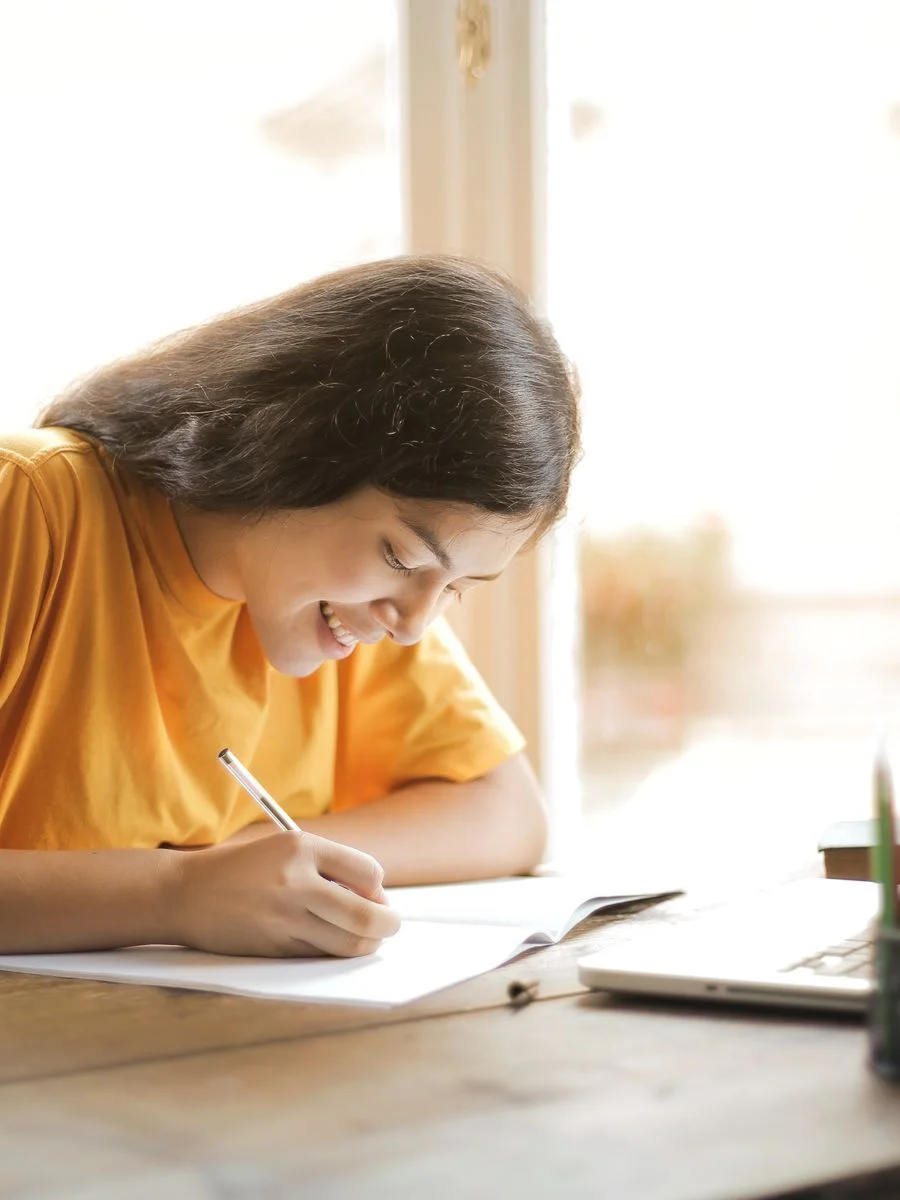 A focused student smiling while studying
