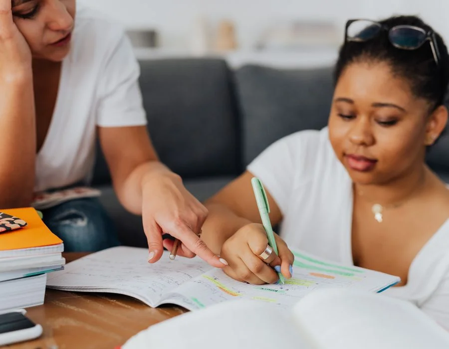 A tutor patiently guiding a student through their work