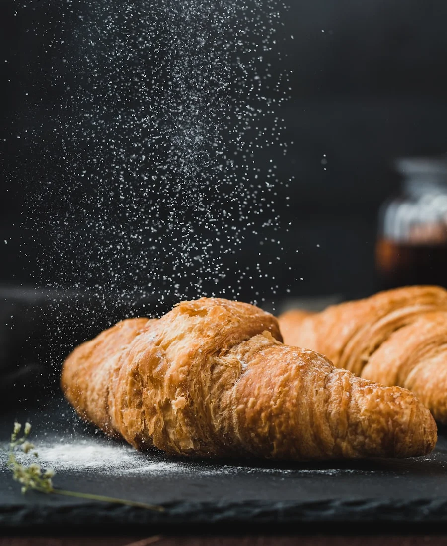 Golden flaky croissant on a ceramic plate